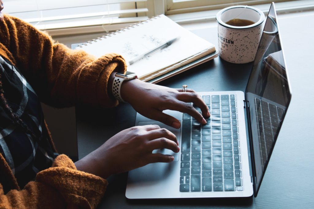 woman typing on a laptop while working from home